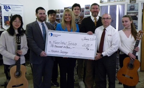Skowhegan team presenting check to Maine Central Institute for $10,000.